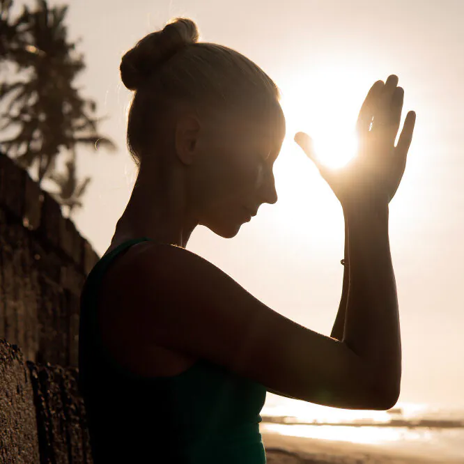 beautiful-woman-meditating-outdoors-e1706710343190