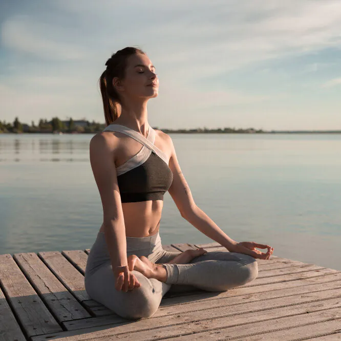 young-sports-lady-beach-make-meditation-exercises-e1706710360387